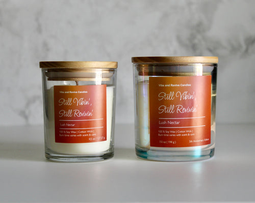 Two candles with labels on a gray background